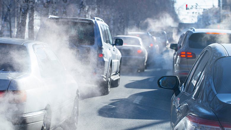 pollution from the exhaust of cars in the city in the winter. Smoke from cars on a cold winter day