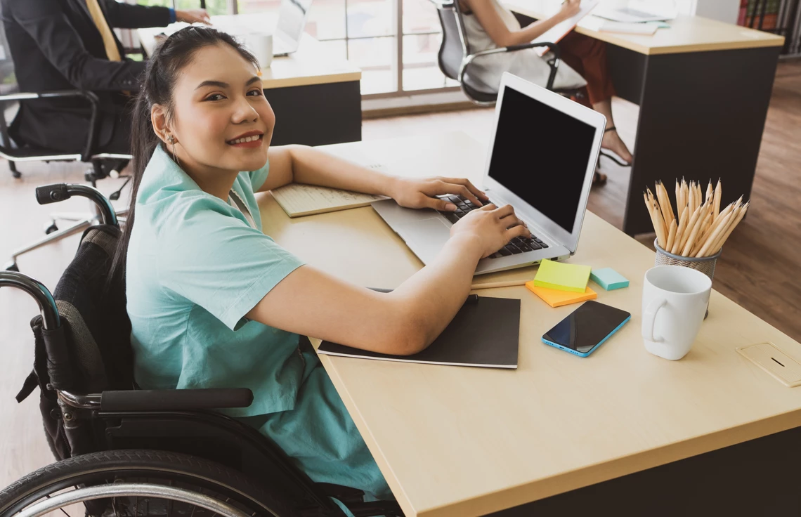 Young Asian woman with smiling face sitting in the wheelchair