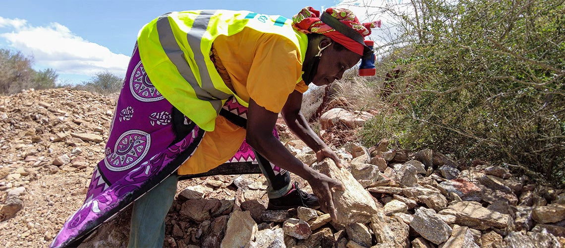 African woman artisanal miner at work.