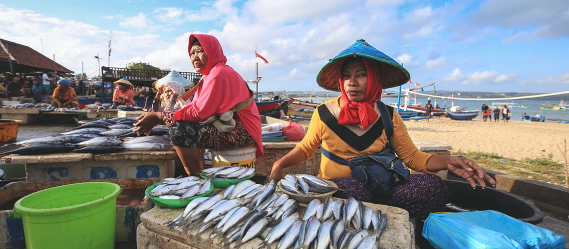 Fishmongers selling fish at the Kedonganan Fish Market, in Bali, Indonesia.