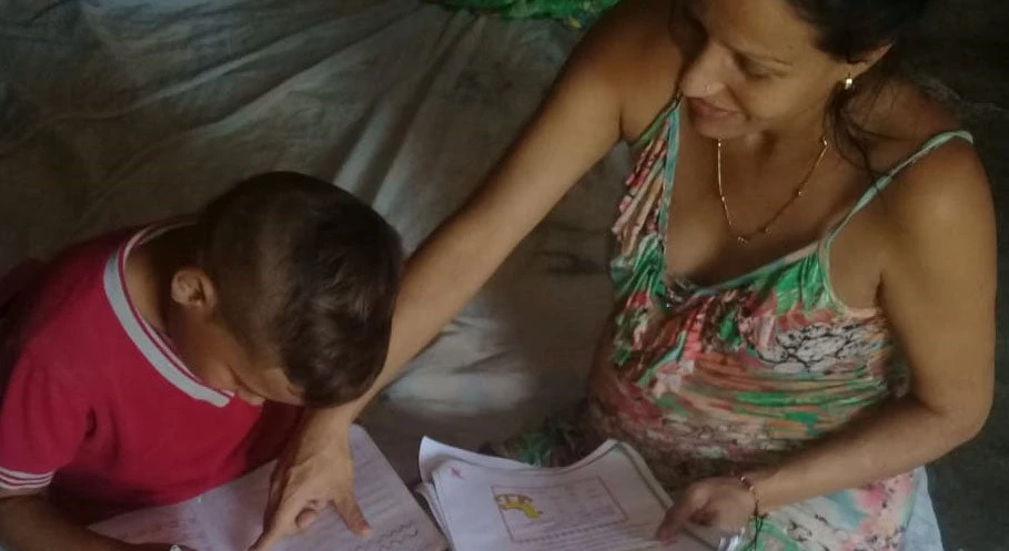 Freder and his mother Graciela review his homework