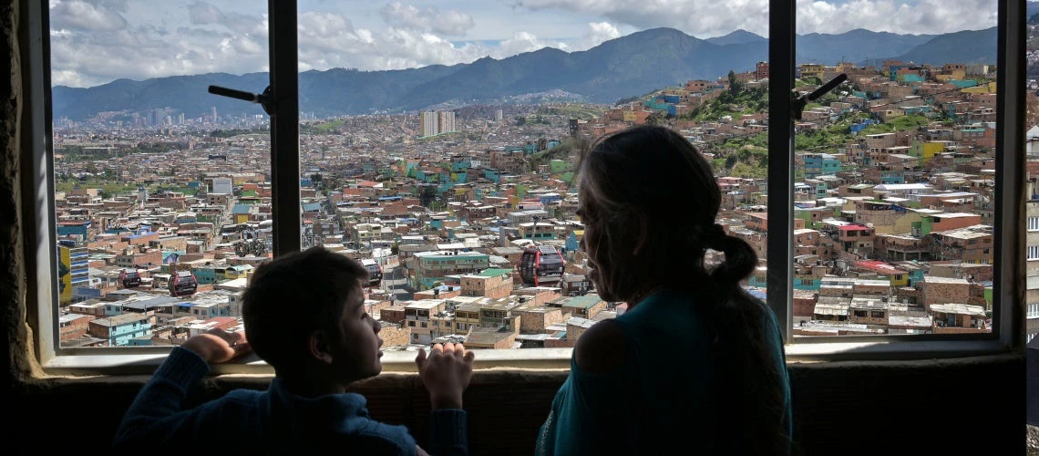 boy and older woman looking out the window