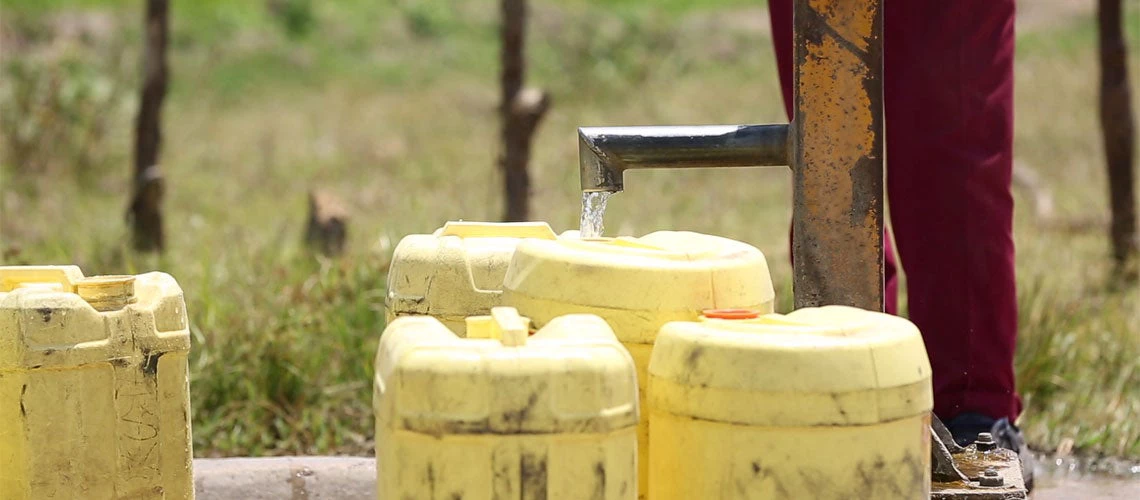 Water tap filling containers in Tanzania. Photo: World Bank