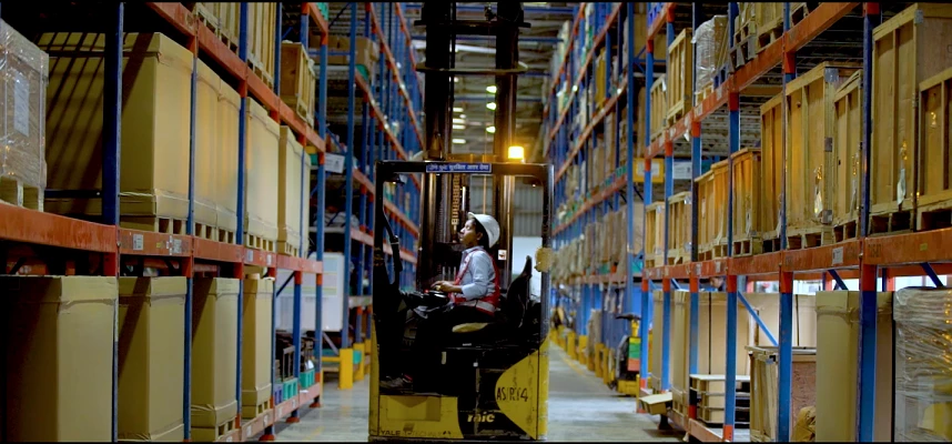 Woman operating a forklift and high-reach stacker