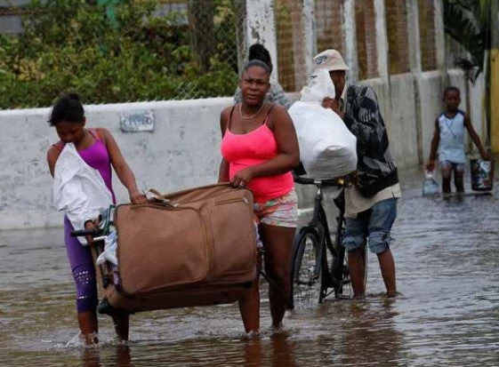 People leave a school used as a shelter after Hurricane Earl, Belize City, Belize