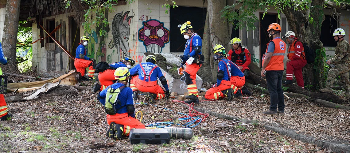 A group of workers participate in the simulation of Disaster Risk Management