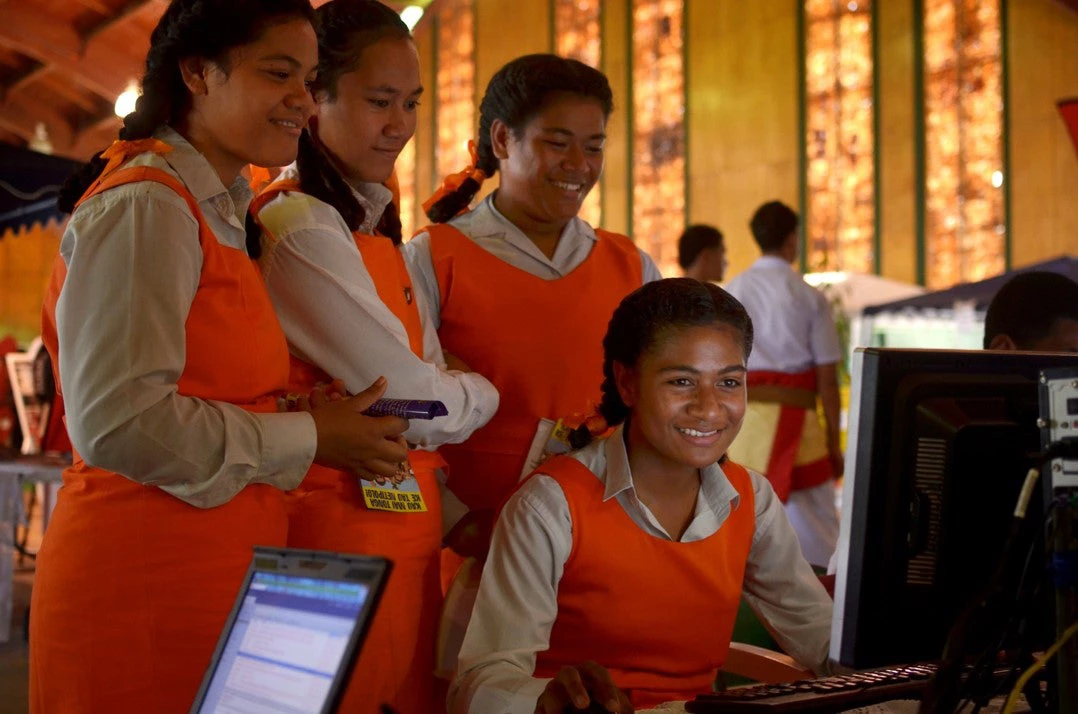 Young girls from Tonga's Tailulu College gather around a computer to sharpen their digital at 2013 World Telecommunication and Information Society Day celebrations in the Tongan capital, Nuku'alofa. 
