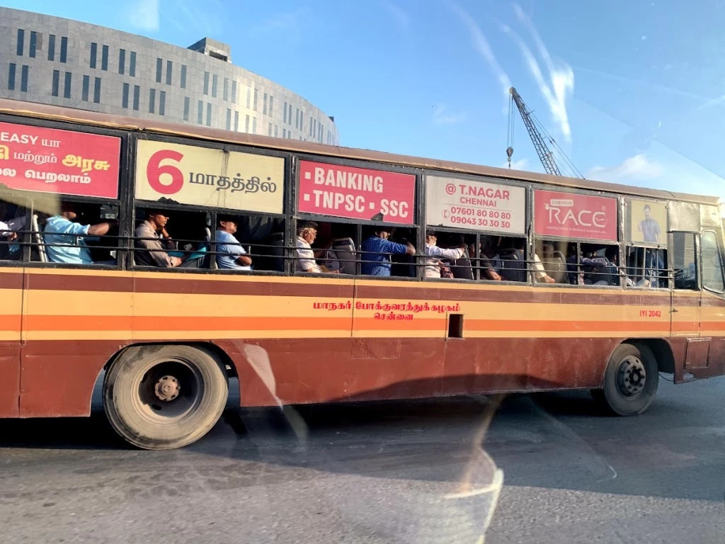 A photo of a bus with passengers of all ages.