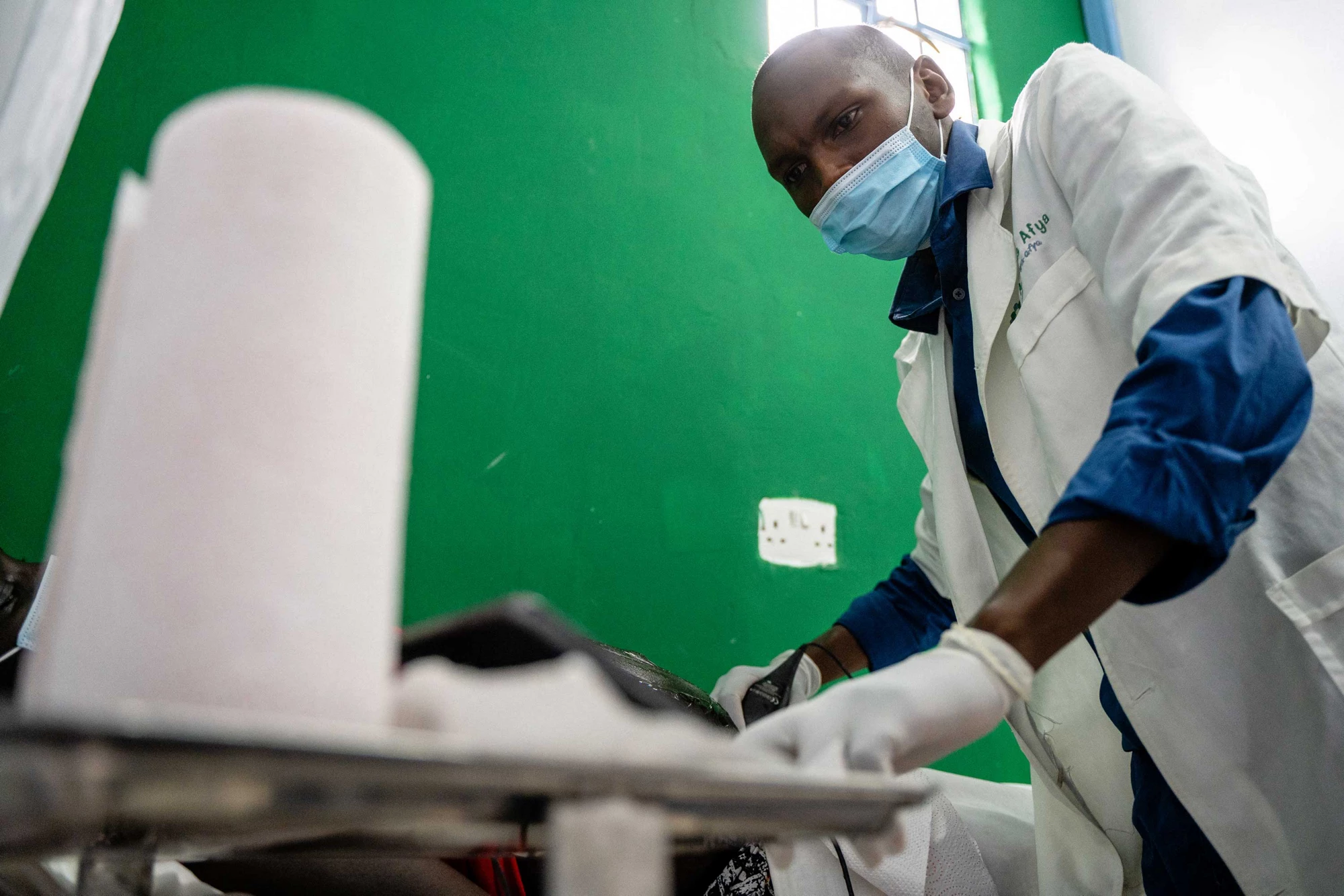 A sonographer at Access Afya administers an ultrasound using Butterfly IQ technology.