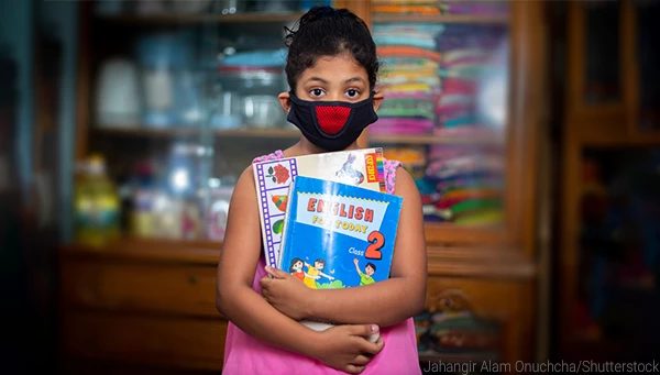 A teenage girl wearing a protective cloth mask against transmissible COVID-19 diseases