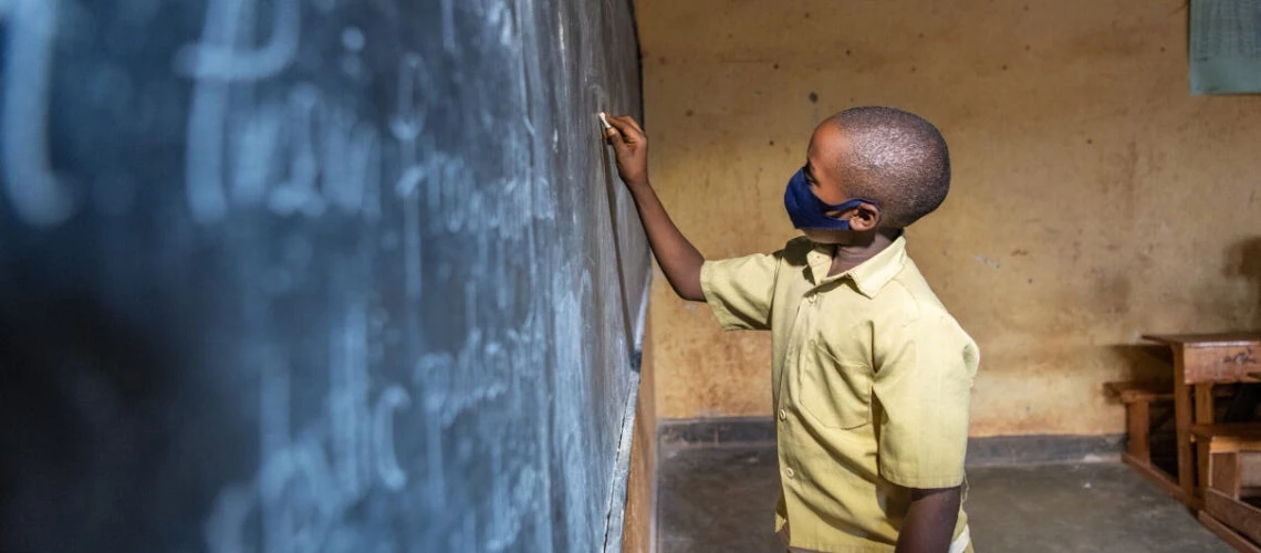 Schoolboy writing on a board