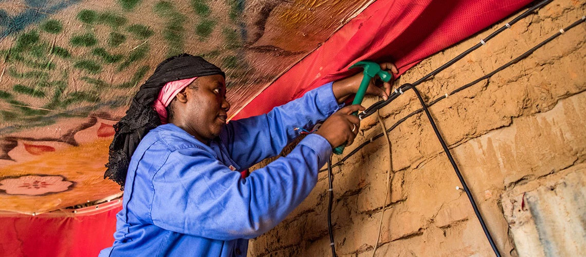 Adaouia Birema works at installing electricity at a client's house in Chad. Photo: Vincent Tremeau/World Bank