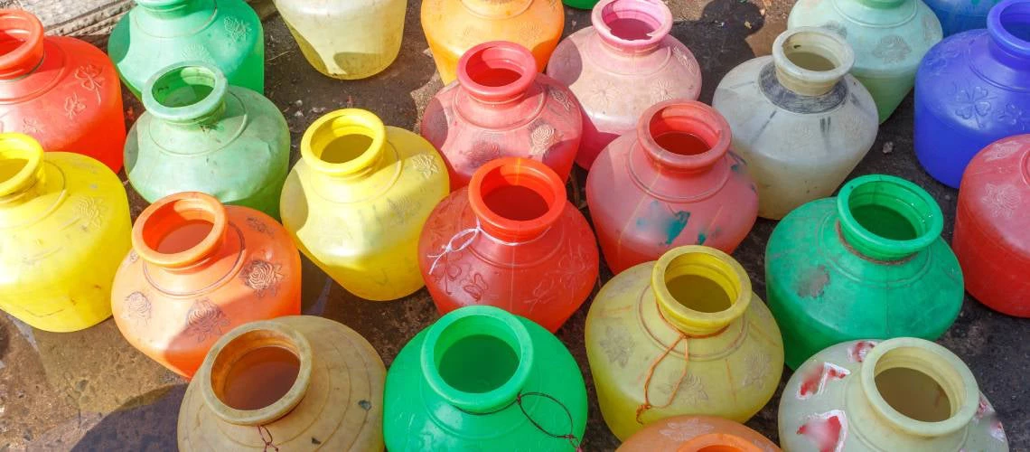Plastic buckets filled with water on a roadside in Chennai, India.