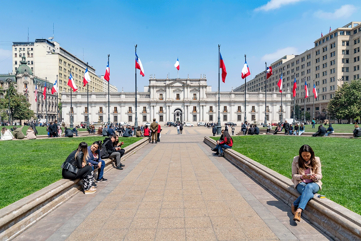 Santiago, Chile - October 12, 2018: La Moneda Palace, Construction began in 1784 and was opened in 1805. People are visiting and resting in the square.