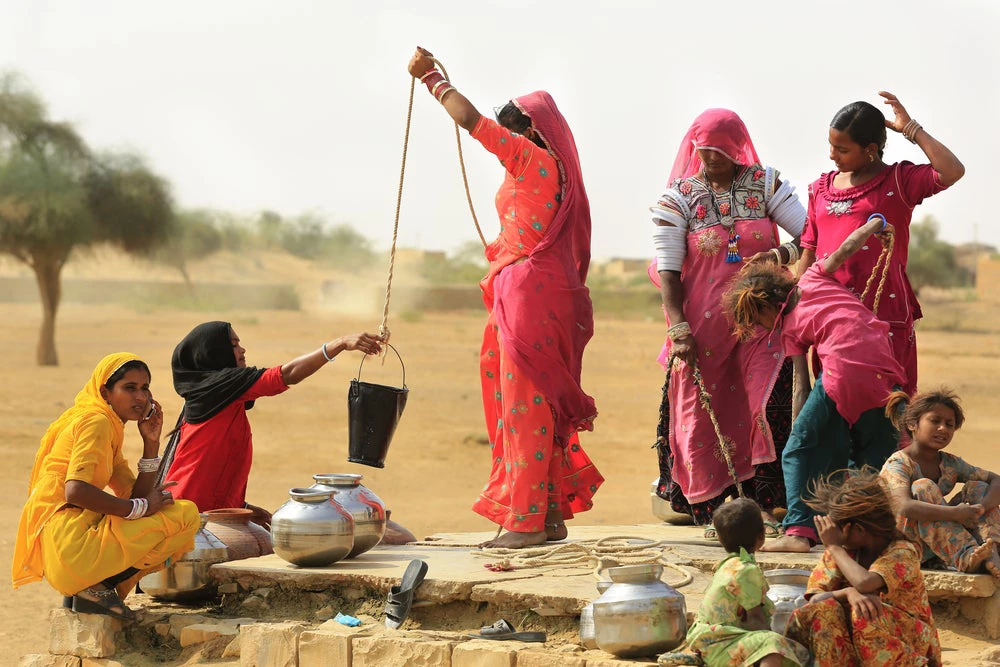 Women in Jaisalmer India draw water from the well