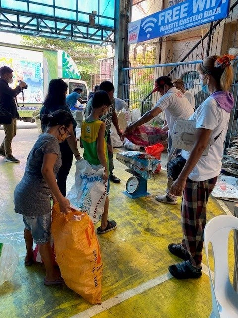 Communities in Metro Manila bring recyclables to collection center.