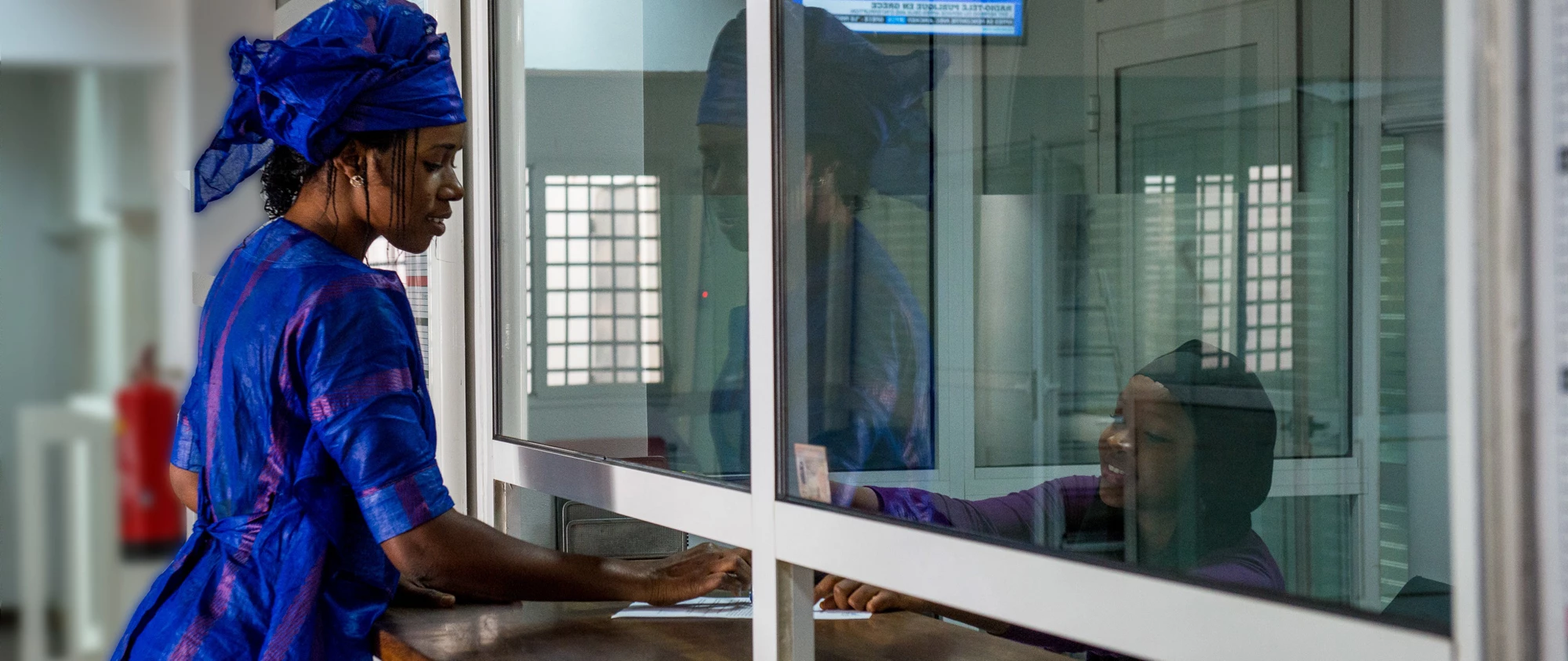 A female conducting a transaction at a bank branch in Nouakchott, Mauritania | © Arne Hoel, World Bank