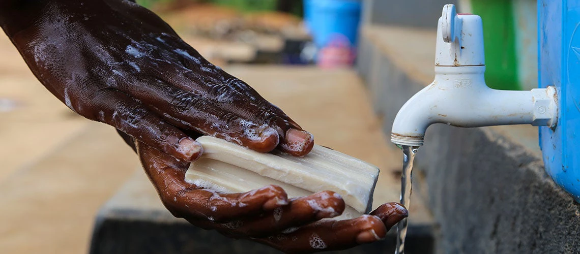 Student washing his hands with water and soap at the Kailahun District Education Committee School (KLDEC). Located in Eastern Sierra Leone, at the border with Guinea and Liberia, Kailahun District was one of the country?s first hotspots in the Ebola outbreak.