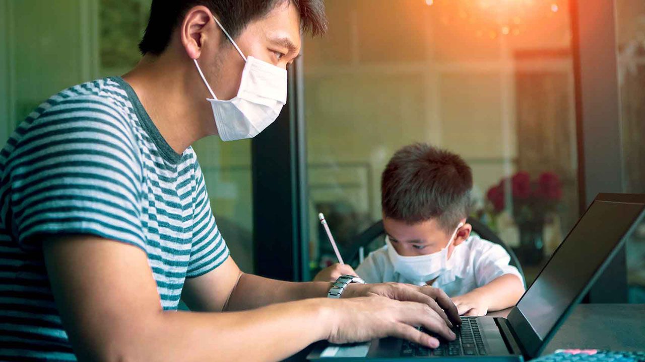 quarantine asian man and children wearing protection mask working on computer at home while covid-19 virus inflected global