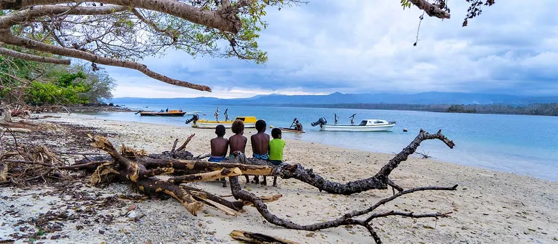 Children sitting on beach in Tongoa Island, Vanuatu after Tropical Cyclone Harold hit in April 2020.