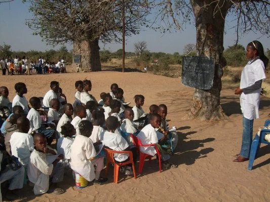 Lucinda Alves with her students at the Caxila school in Ongiva