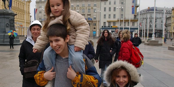 Children walk through Zagreb city square.