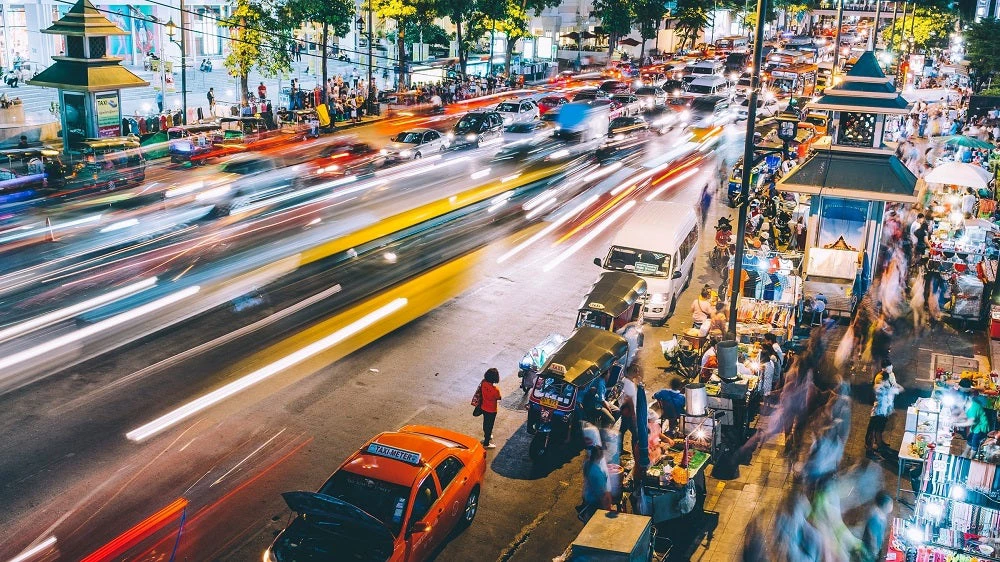Picture of blurry cars driving on street at night in Bangkok, Thailand
