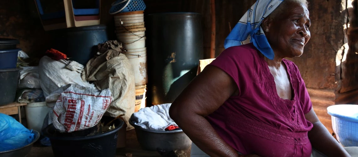 Ester Awo Bartey sits near her home in Ghana. . Resolving the impasse in debt restructurings, especially for the world?s poorest countries, is going to be center stage at the 2023 IMF/World Bank Spring Meetings.. 