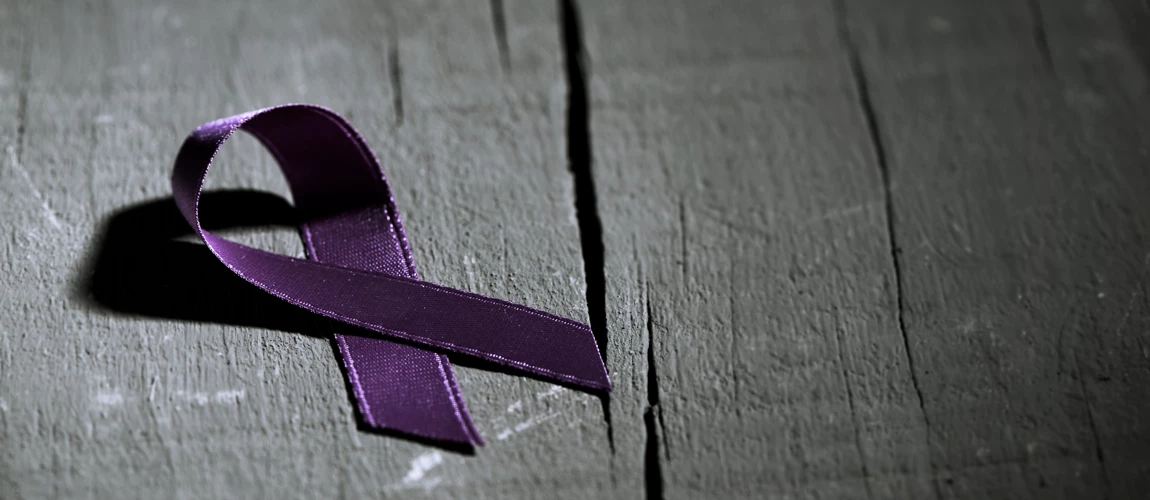 A purple ribbon for the awareness about the unacceptability of the violence against women