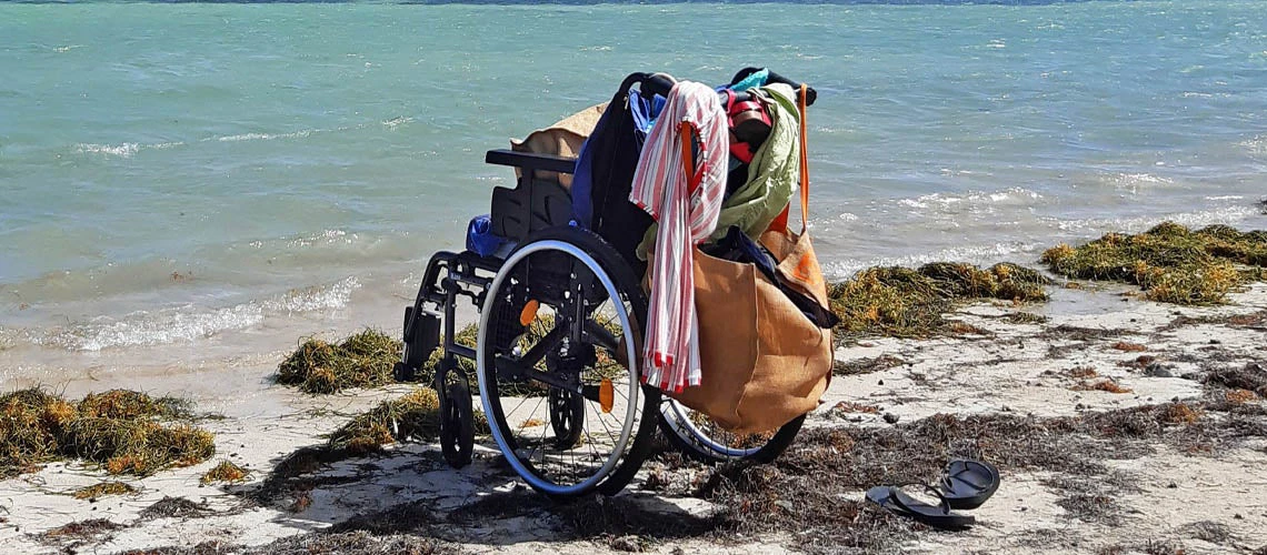 A wheelchair by the ocean.