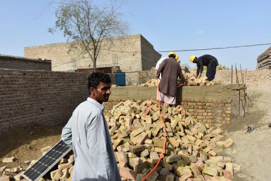 Wall level construction after receipt of 2nd tranche. House owner Wazira, Village Dur Muhammad Abro, District Dadu, Sindh, Pakistan. Photo: Kamran Akbar