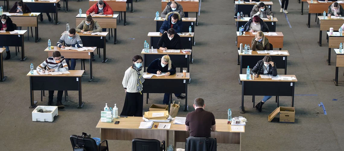 Students undertaking a written exam, Romania.