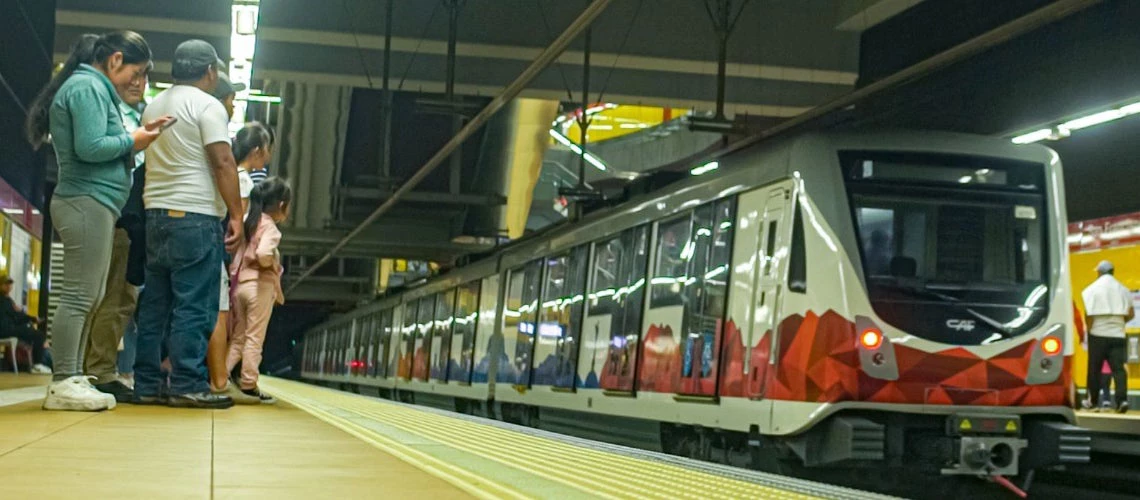 Men, women and children about to board on the Metro One Line in Quito, Ecuador 