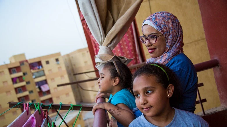 Azza and her daughters in their new home.