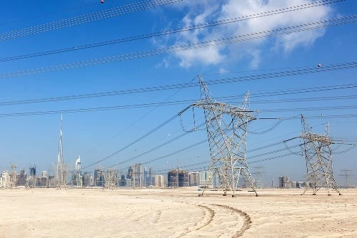 Skyline of Dubai with high voltage power supply lines - Philip Lange l Shutterstock.com