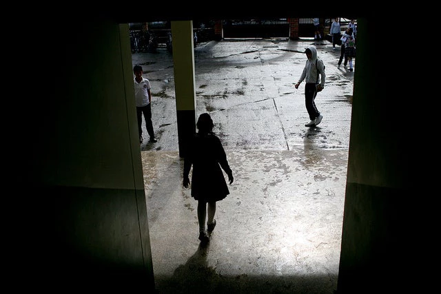 A Girl Entering a High school Courtyard © Charlotte Kesl / World Bank