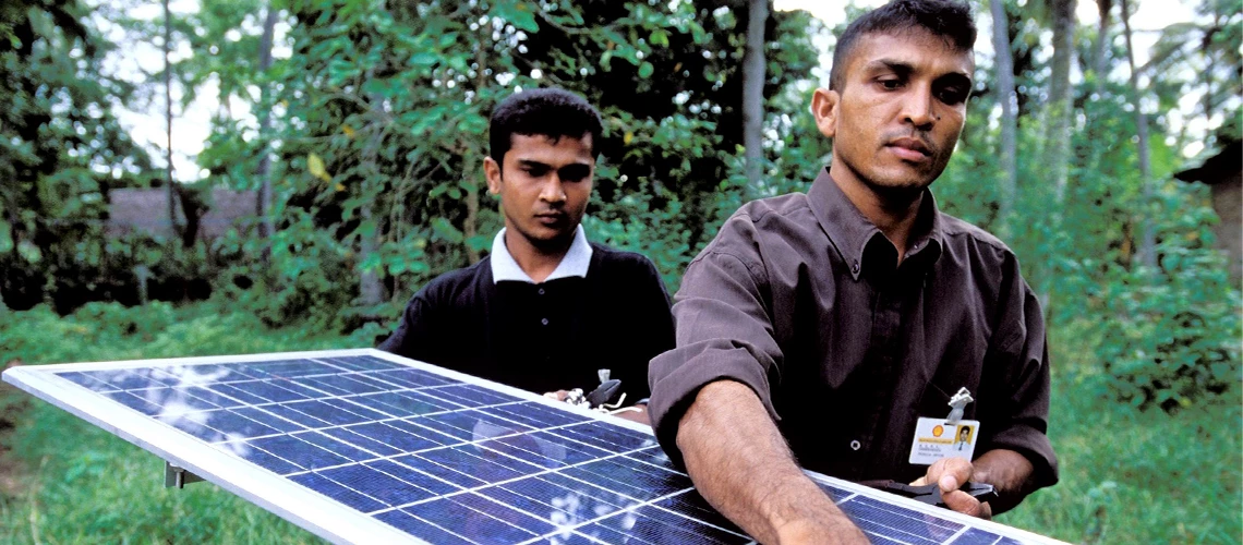  Installing solar panels to light village homes. Photo: © Dominic Sansoni / World Bank