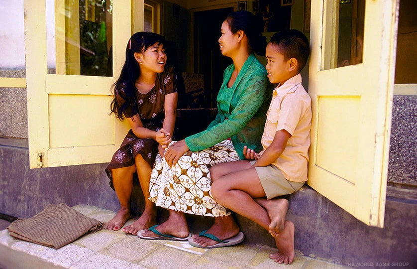 Family sitting ni the doorway, Indonesia