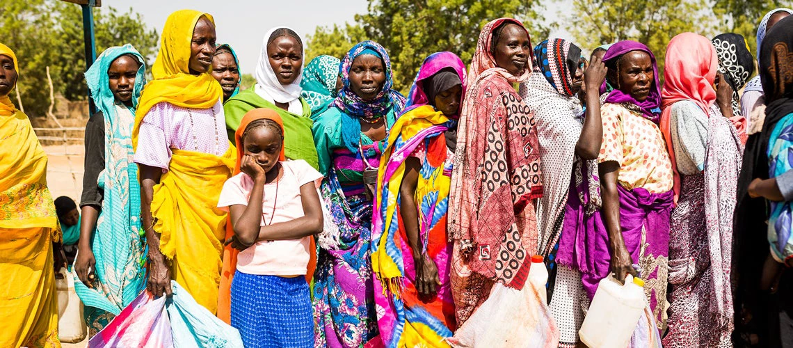 Refugee families wait at a food distribution point. © 2018 European Union (photo by Dominique Catton)