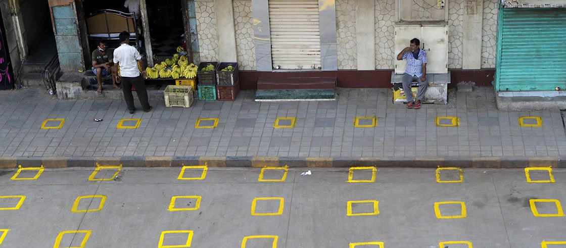 Positions are marked for maintaining physical distance at a market in Mumbai, India. Photo: Rajanish Kakade/?AP/?Shutterstock