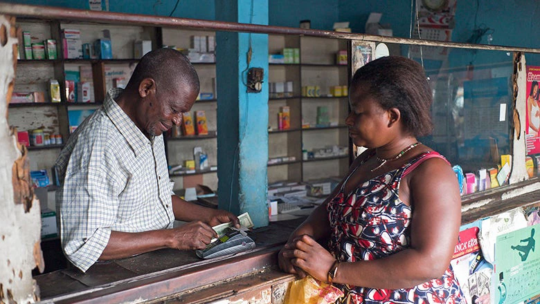 A digital transaction in the Democratic Republic of Congo. Such transactions are made possible in part by FINCA. FINCA's strategy in Africa is to focus operations on underserved markets and groups, namely rural areas and women. Photo: Anna Koblanck/IFC