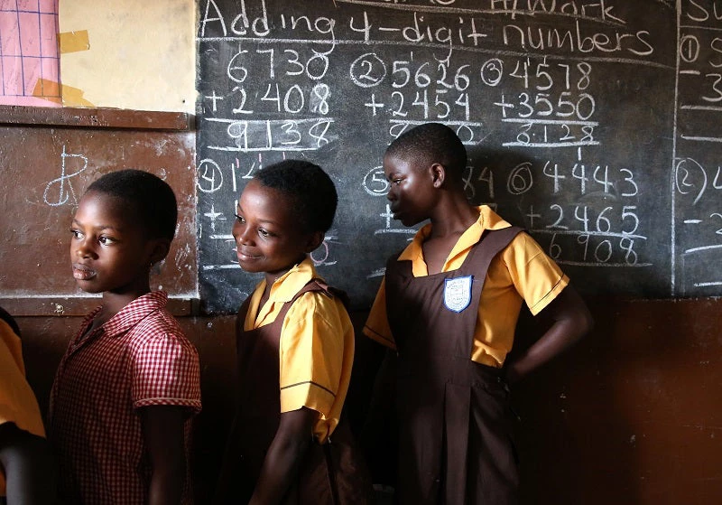 Students line up to wash their hands before eating at Kanda Estate Primary School in Accra, Ghana