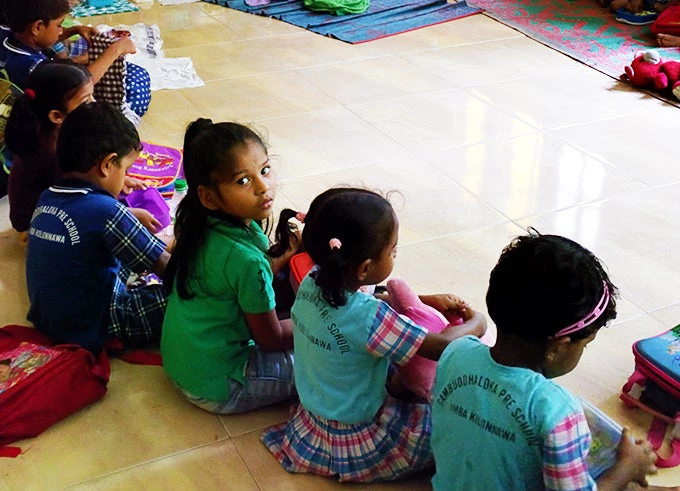 3.  Students of the Sri Sambuddhaloka Preschool sit down to have morning snacks 