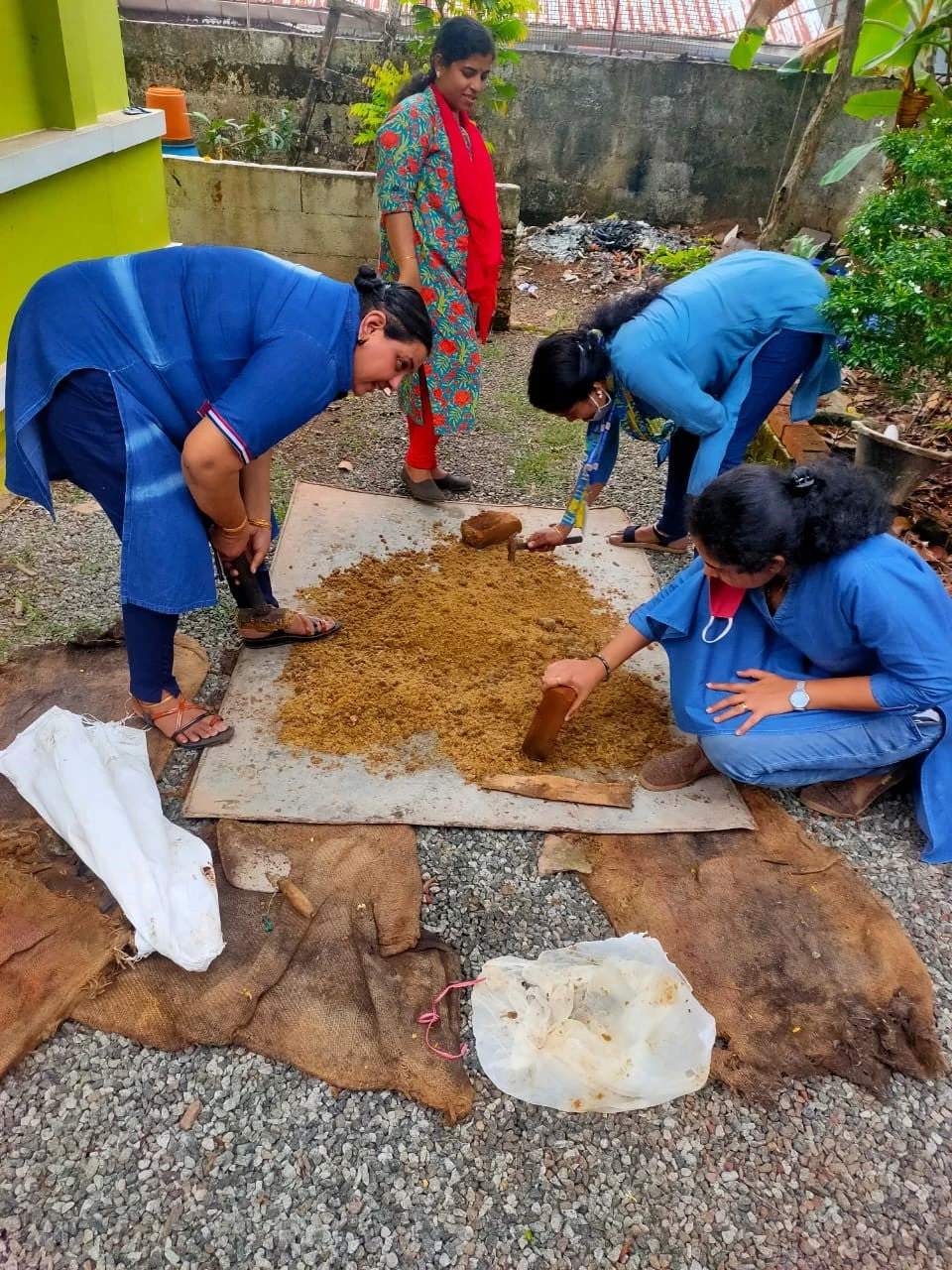 Department of agriculture mixing jaggery powder with copper sulphate for making the snail trap. Photo Credit: World Bank