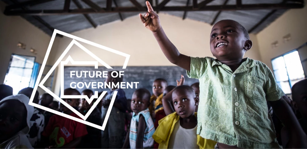 The Future of Government postcard - boy reaching upward, smiling, in classroom