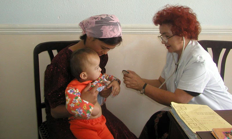 General practitioner examines baby