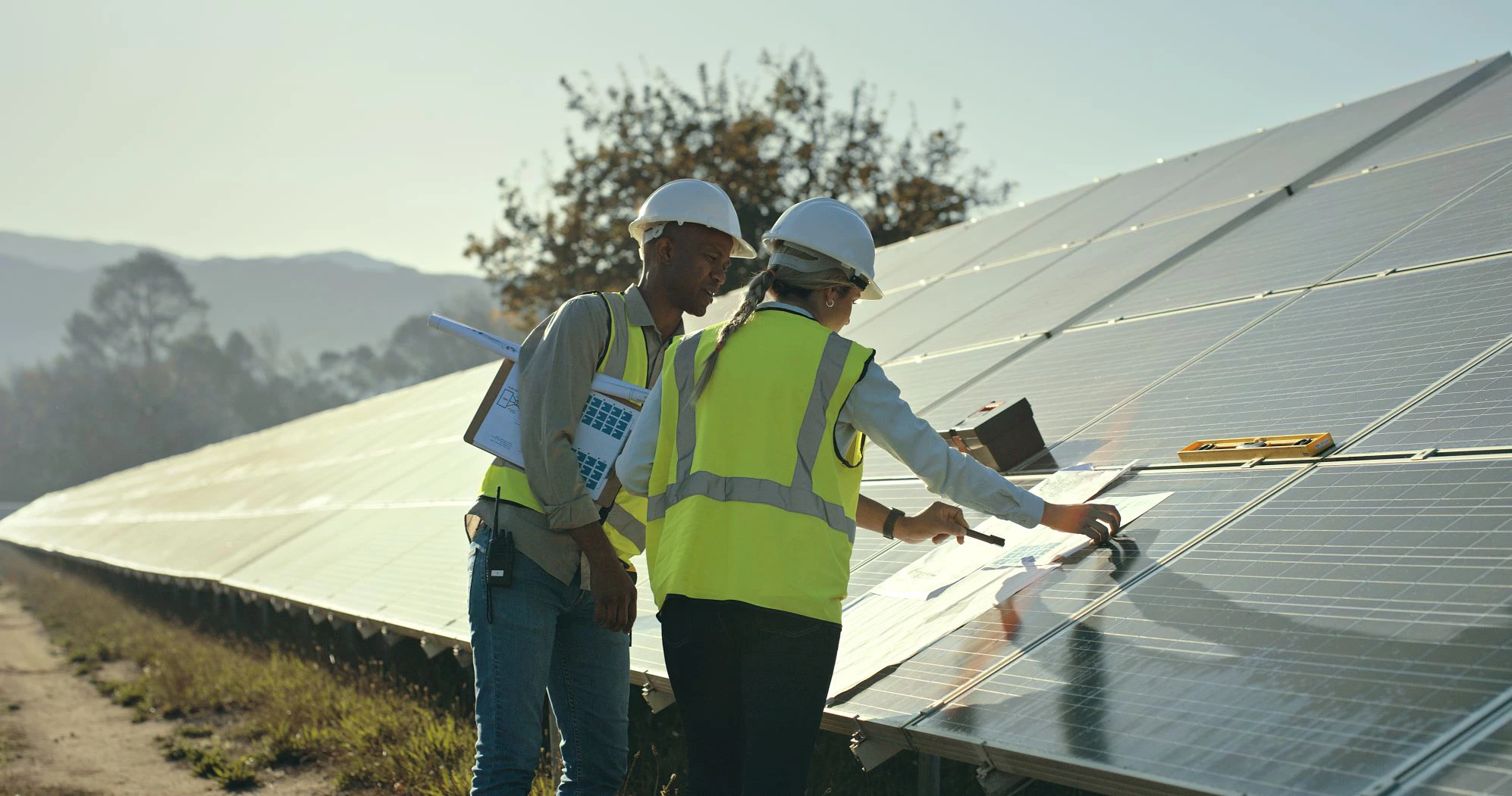 Man and woman engineers working on solar panel. (Getty Images)