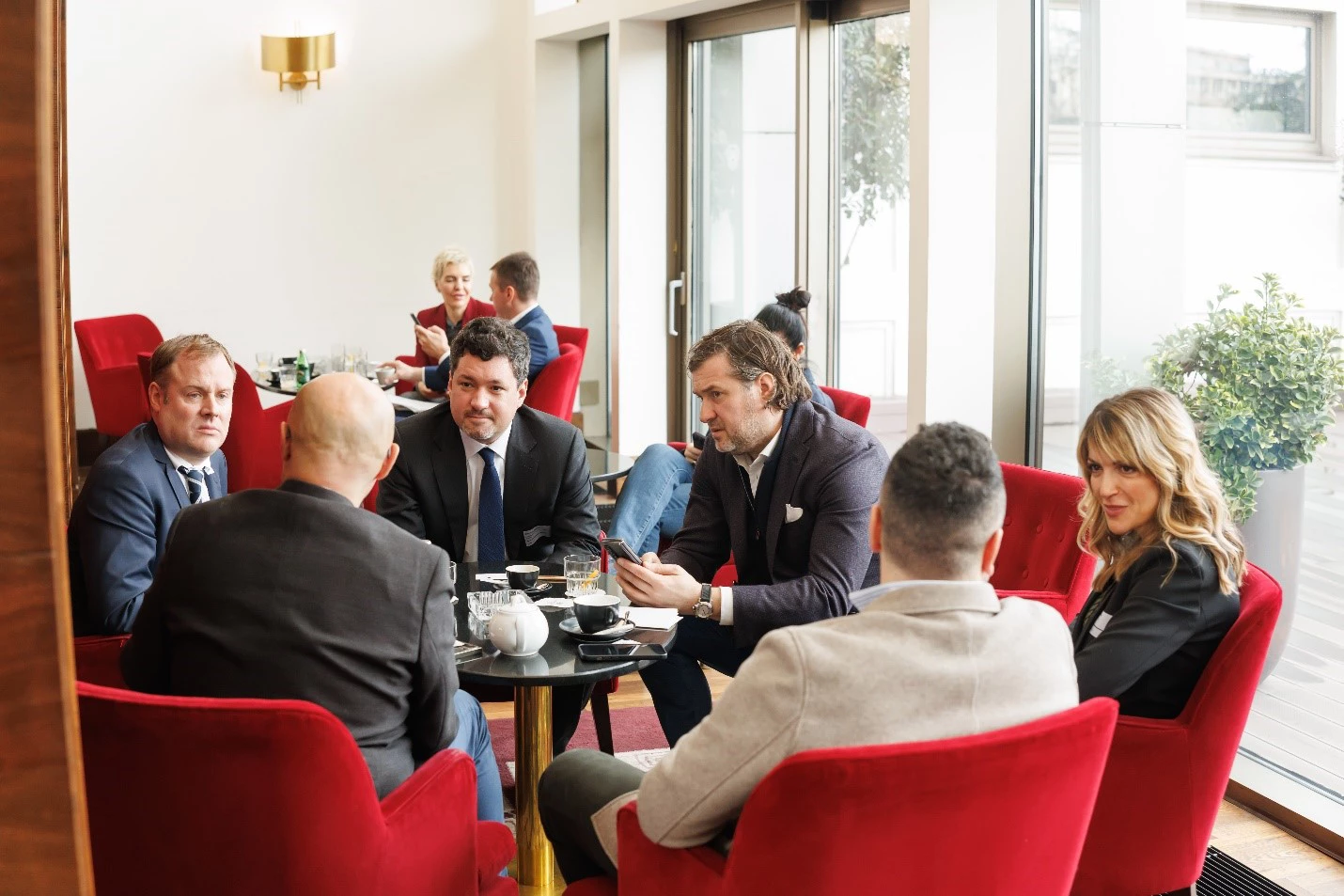 Participants engage in informal networking during a break at the Western Balkans Green Growth Alliance Launch Event.