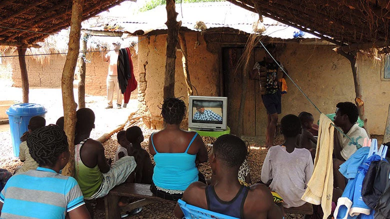 People watching a television powered by solar