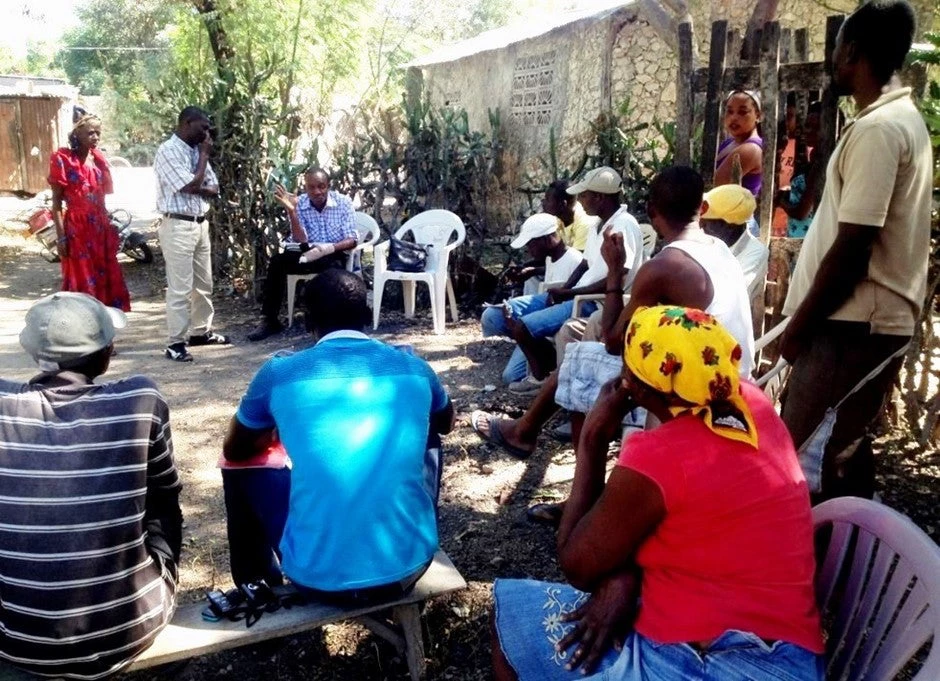 Small farmers in Haiti discussing a new common service to export mangoes and avocados directly to the US